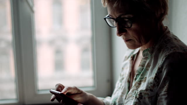 Woman-watching-something-on-the-smartphone-screen