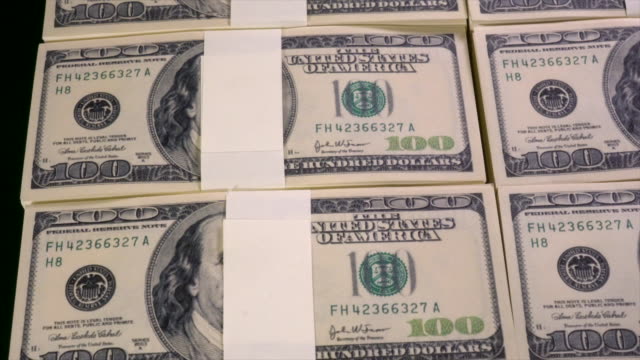 Stacks-of-US-dollars-in-hundred-dollar-banknotes.