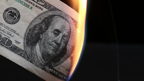 Dollar-bill-in-flames.-American-money-burning-on-black-background.