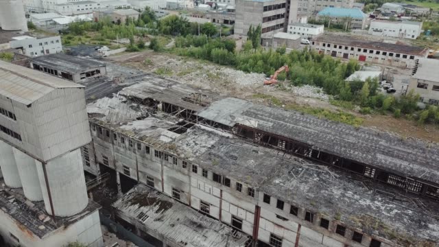 Flying-over-abandoned-industrial-factory-buildings-in-very-dilapidated-condition.
