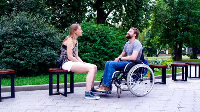 Young-disable-man-with-his-wife-sitting-in-the-park