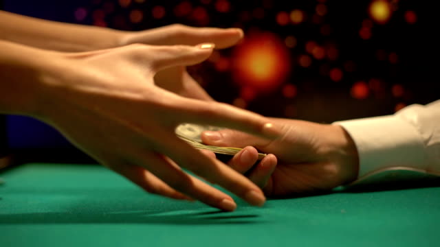 Poker-player-giving-money-to-female-croupier,-buying-gambling-chips,-casino