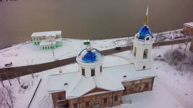 Aerial-view-of-Church-in-Russia.-Clip.-Small-town-Church-during-snowy-winter-in-a-small-town