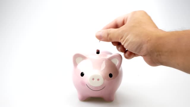Sparschwein-Geschäft-steht-auf-einem-Haufen-von-Münzen-Konzept.-Geld-sparen-ist-eine-Investition-in-die-Zukunft.-Bankinvestitionen-und