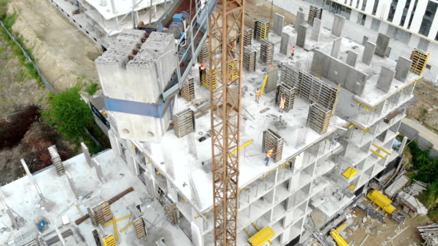 Flight-near-the-unfinished-monolithic-house.-Construction-crane-near-the-construction-site.-Top-view-of-the-construction