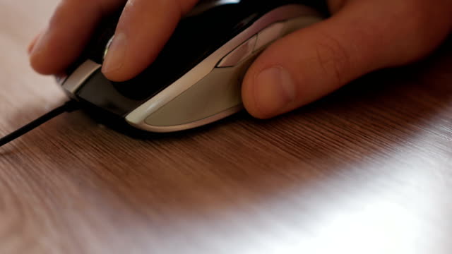 Man-hand-clicking-computer-mouse.-Mouse-in-hand-businessman.-Closeup.