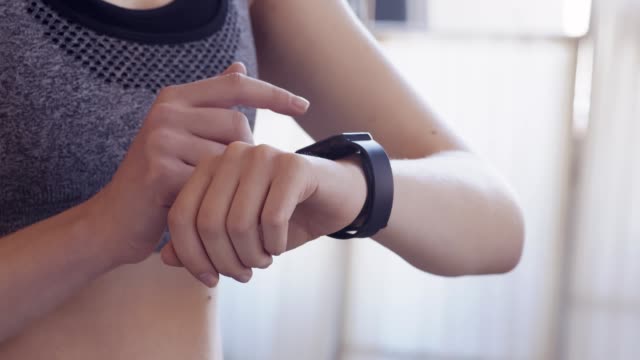 Woman-watching-her-intensive-training-results-on-smartwatch