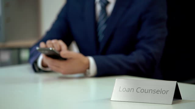 Loan-counselor-using-smartphone,-providing-debt-settlement-services-to-client