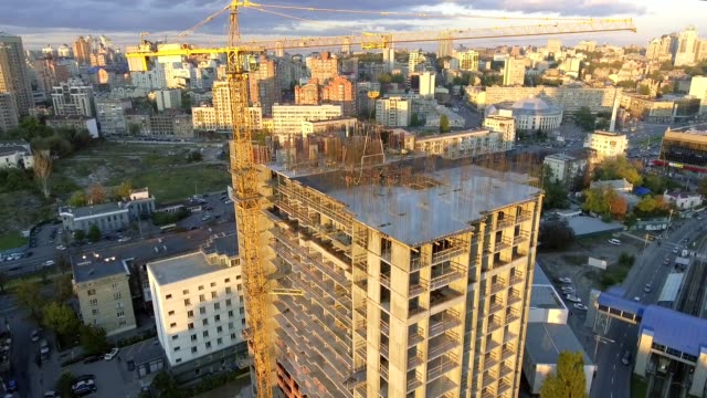 Industry-construction-and-development.-Workers-building-a-new-house.Aerial-shot.The-camera-moves-from-the-top-down