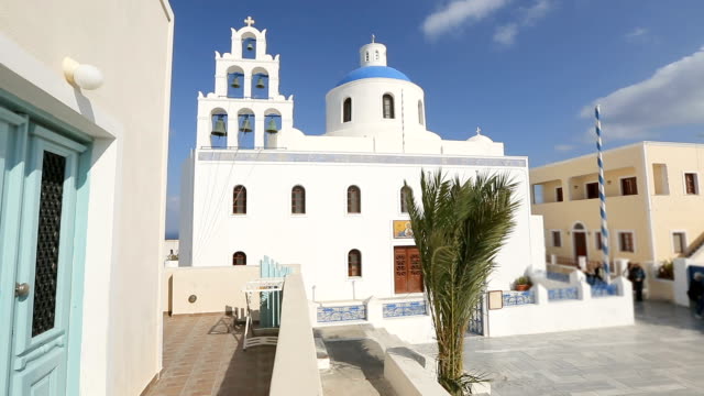 Orthodox-church-in-white-against-blue-clear-sky-on-Santorini,-Greece,-religion