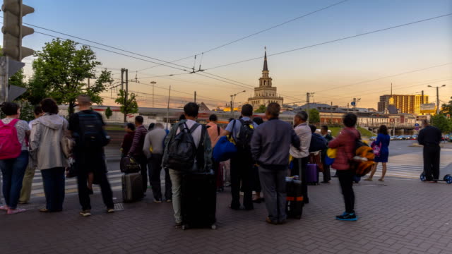 the-flow-of-tourists-at-the-busy-intersection-near-the-railway-station,-time-lapse