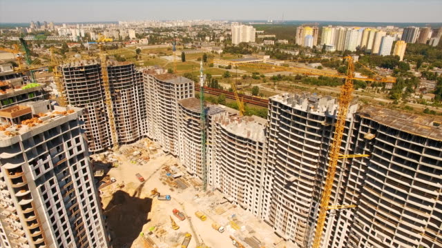 Aerial-shoot-of-construction-site-with-tower-cranes.-Construction-drone-footage