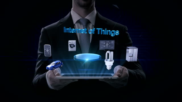 Businessman-lifting-smart-pad,-'Internet-of-things'-connecting-mobile,-car,-energy-saving,-washer,-refrigerator,-smart-home-devices,-4k-movie.