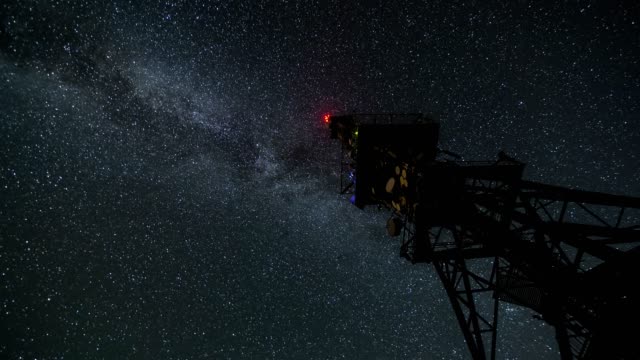 Milky-way-galaxy-moving-over-communication-tower-in-starry-night-Time-lapse