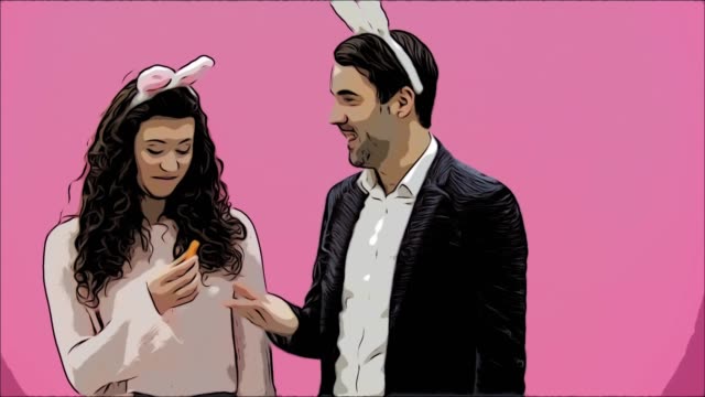 Young-couple-are-beautiful-on-pink-background.-During-this-time,-they-are-dressed-in-rabble-ears.-Looking-at-each-other,-speaking-and-smiling,-behave-like-rabbits.-Surrendering-leaves-the-frame.