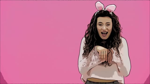 Beautiful-young-girl-standing-on-a-pink-background.-During-this,-there-are-ears-of-rabbits-on-the-head.-Performs-rabbit-rhythmic-jumps.-Has-beautiful-black-long-hair.
