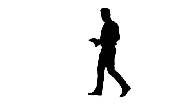 Silhouette-Happy-businessman-walking-in-and-using-tablet-turning-on-something-or-opening-something