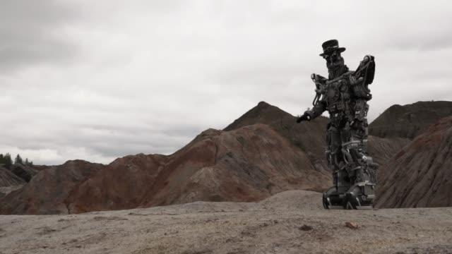 Robot-walking-in-a-desert-landscape.-Footage.-Android-robot-in-the-mountain-desert-in-cloudy-weather