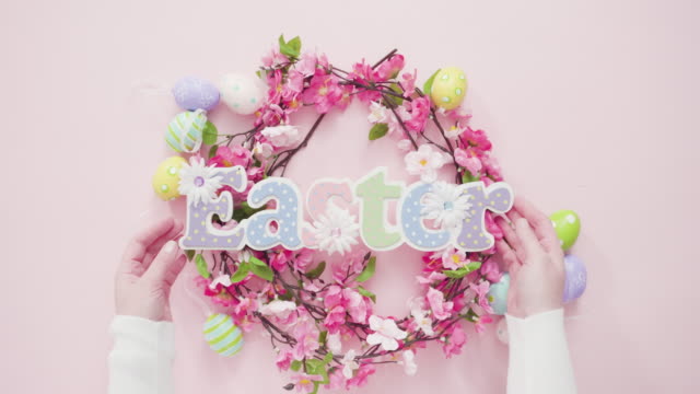 Easter-eggs-and-pink-flowers-on-a-pink-background.