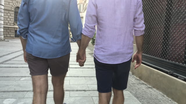 Gay-couple-exploring-a-city-in-Europe