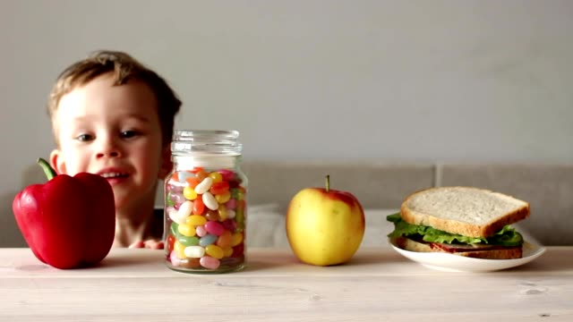 cute-little-boy-with-jar-of-colorful-candy