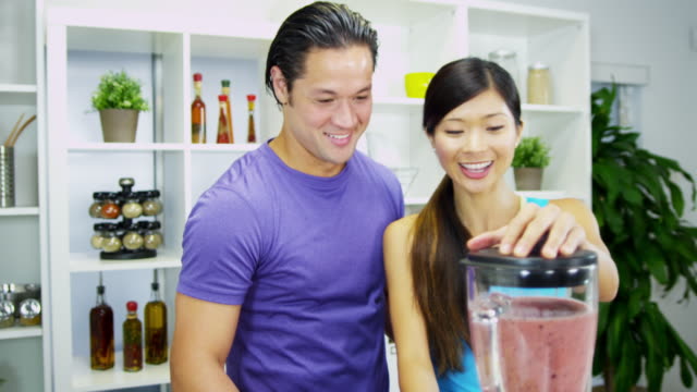 Healthy-lifestyle-Ethnic-couple-making-organic-fruit-smoothie