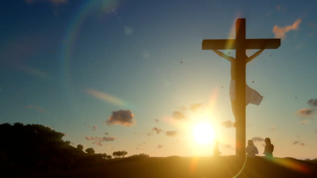 Christians-praying-at-Jesus-cross-at-sunrise,-zoom-out
