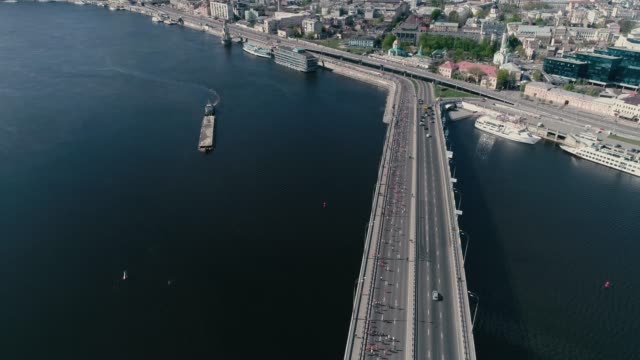 4K-Aerial-drone-fooage.-Marathon-running-on-the-bridge.-Wide-shot.