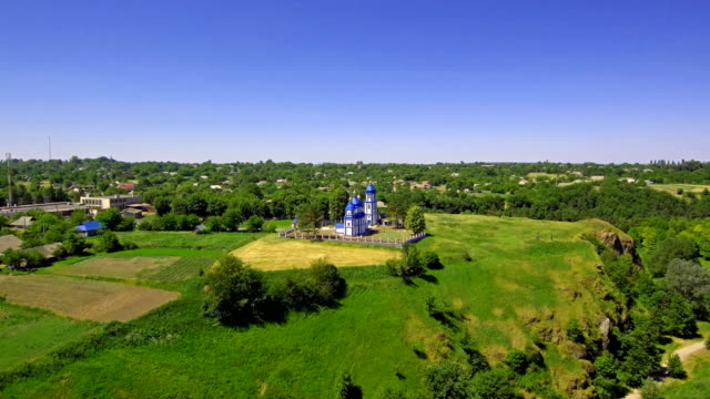 drone-soars-along-the-cliff-revealing-a-view-of-the-church-and-village
