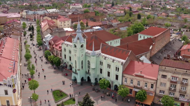 Aerial-view-Peace-Square-of-Mukachevo.-Nearby-is-the-Gothic-chapel-of-St.-Joseph,-city-hall-і-Cathedral-Church-of-St.-Martine.-Eastern-Carpathian-mountains.-Ukraine