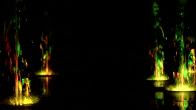 Fuente-de-agua-de-la-noche-bailando-con-fondo-de-imágenes-de-blur-multicolores-luces-de-color,-planos,-profundidad-de-campo,-59,94-fps