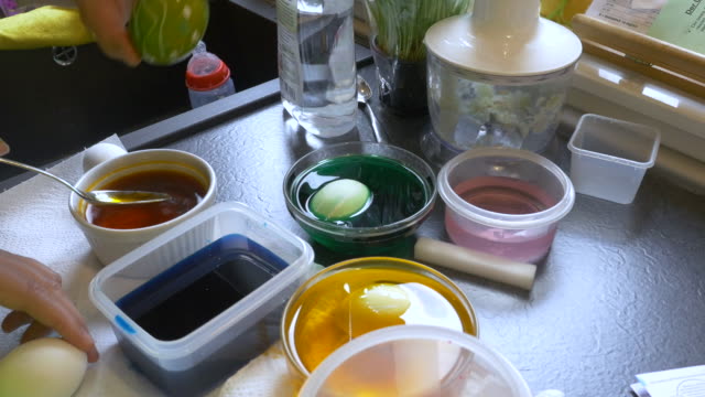 Easter-Egg-Painting-Table-With-People's-Hands-Visible