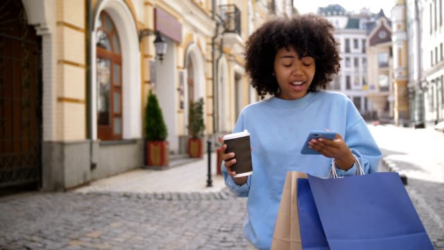 Cute-mixed-race-girl-busy-with-cellphone-on-street