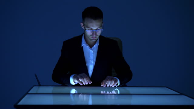 The-businessman-working-with-touchscreen-display
