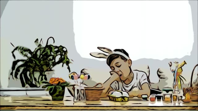 Cute-nice-boy-is-sitting-at-the-table,-but-got-tired-and-decided-to-have-a-rest.-Boy-is-yawning.-At-the-end-he-notices-interesting-bunnies-and-plays-with-them.-Playful-boy.