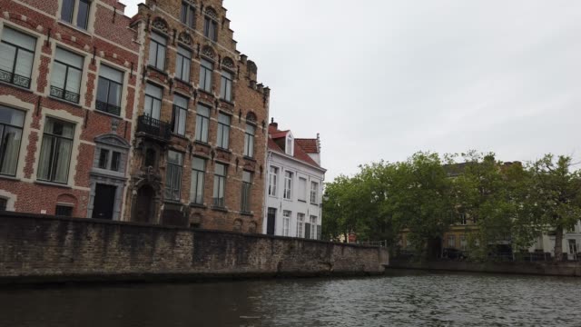 Bruges,-Belgium---May-2019:-View-of-the-water-channel-in-the-city-center.-Tourist-walk-on-the-water-canals-of-the-city.-View-from-a-tourist-boat.
