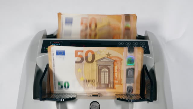 Top-view-of-money-calculating-machine-with-euros