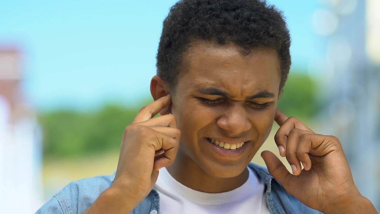 Teenage Boy Closing Ears From Pain, Suffering Buzzing Noise, Hearing