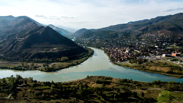 FullHD-Timelapse.-View-from-Jvari-Monastery-on-the-city-Mtskheta-and-confluence-of-the-Aragvi-and-Kura-rivers.-Afternoon,-blue-sky,-running-clouds,-mountains.