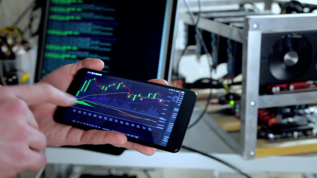 Crop-trader-showing-smartphone-with-cryptocurrency-value