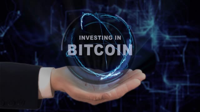 Painted-hand-shows-concept-hologram-Investing-in-Bitcoin-on-his-hand