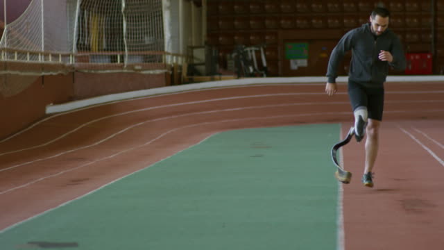 Runner-with-Prosthetic-Limb-Warming-Up-on-Track