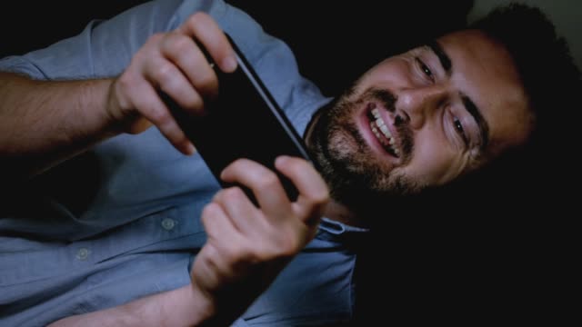 One-happy-man-using-smartphone-at-night