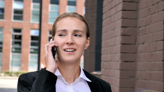 Walking-Businesswoman-Talking-on-Phone