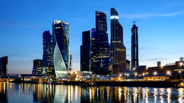 Day-to-night-hyperlapse-of-Moscow-City-(Moscow-International-Business-Center)-and-calm-Moskva-river,-Russia.