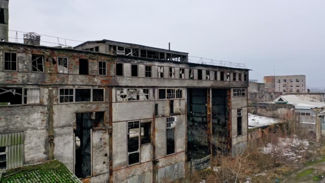 Old-abandoned-plant-with-broken-windows-ruined-after-the-military-actions.