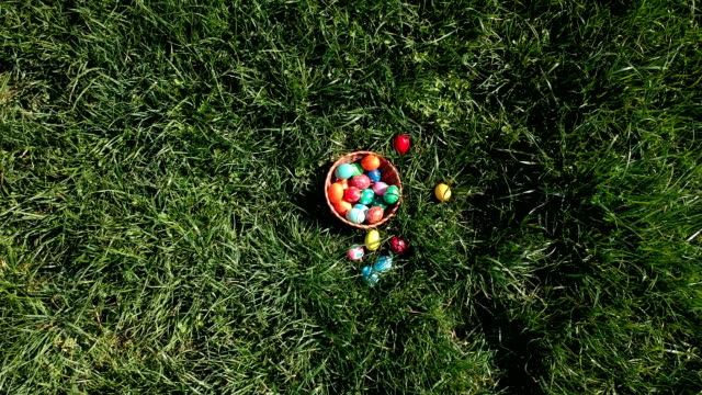 colorful-easter-eggs-in-the-fresh-spring-meadow,-aerial-view