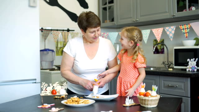 Little-Girl-and-Grandma-Having-Fun-while-Cooking