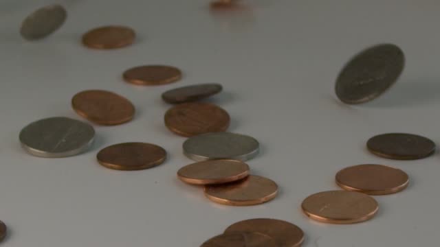 Extreme-slow-motion-in-300-FPS-of-coins-flipping-on-a-table