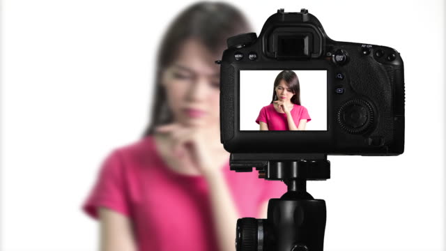 Asian-American-woman-having-eureka-moment-on-camera,-creating-content-for-social-media